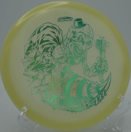 2025 LE Halloween Single Stamped Mega Glo Buzzz glowing bright on approach at Raven’s Ridge Disc Golf Course in Fairbanks, Alaska.