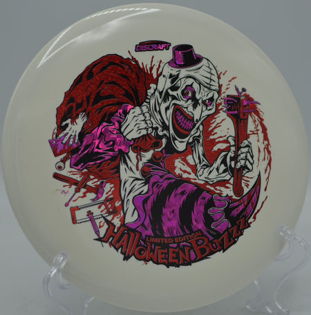 2025 LE Halloween Glo Triple Stamped Buzzz glowing on approach at Renaissance Gold Disc Golf Course in Charlotte, North Carolina.