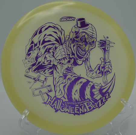 Discraft Halloween Single Stamped Mega Glo Buzzz 2025 edition soaring flat under the night sky at Sugaree Disc Golf Course in Newland, North Carolina.