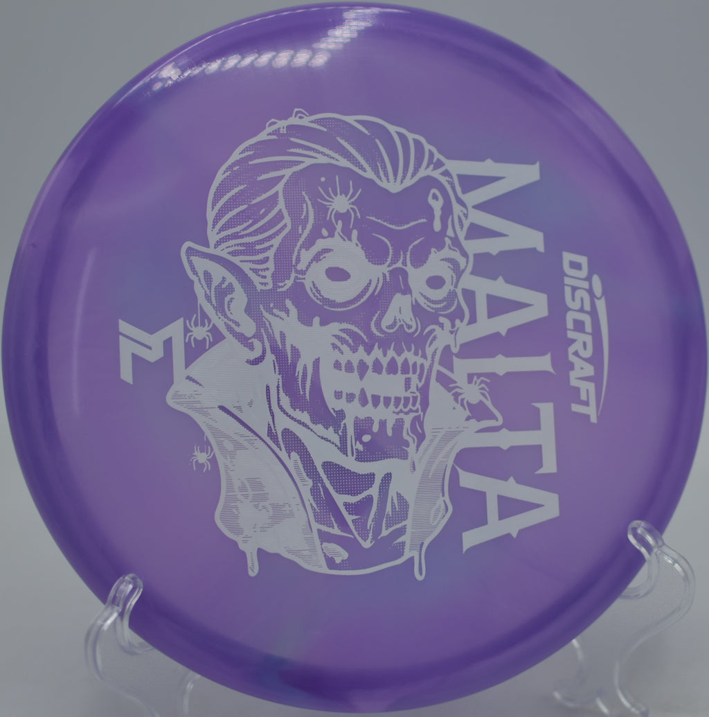 Paul McBeth Signature Z Swirl Dracul Malta landing softly on the green after a clean release at Picnic Island Park Disc Golf Course in Tampa, Florida.