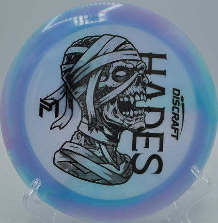 Player unleashing the Mummified Hades on a max-distance flex line at Blue Ribbon Pines Disc Golf Course in East Bethel, Minnesota.