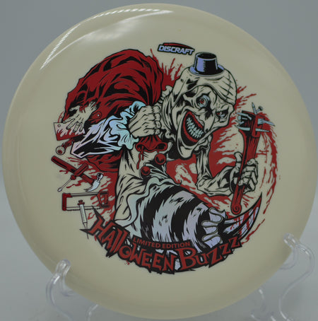 2025 Halloween Glo Triple Stamped Discraft Buzzz ripping a midrange drive at Stafford Woods Disc Golf Course in Voorhees, New Jersey.