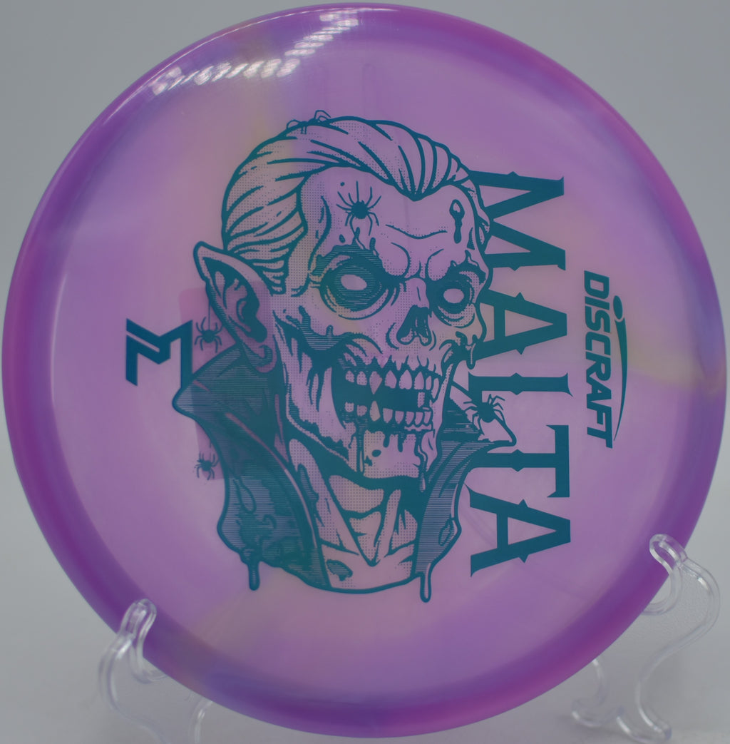 Discraft Dracul Malta mid-flight over sandy fairways at Markham Park Disc Golf Course in Sunrise, Florida.