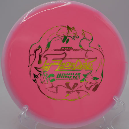 Two-tone Halo Star Fox fairway driver resting on the tee pad at Morley Field Disc Golf Course in San Diego, California.