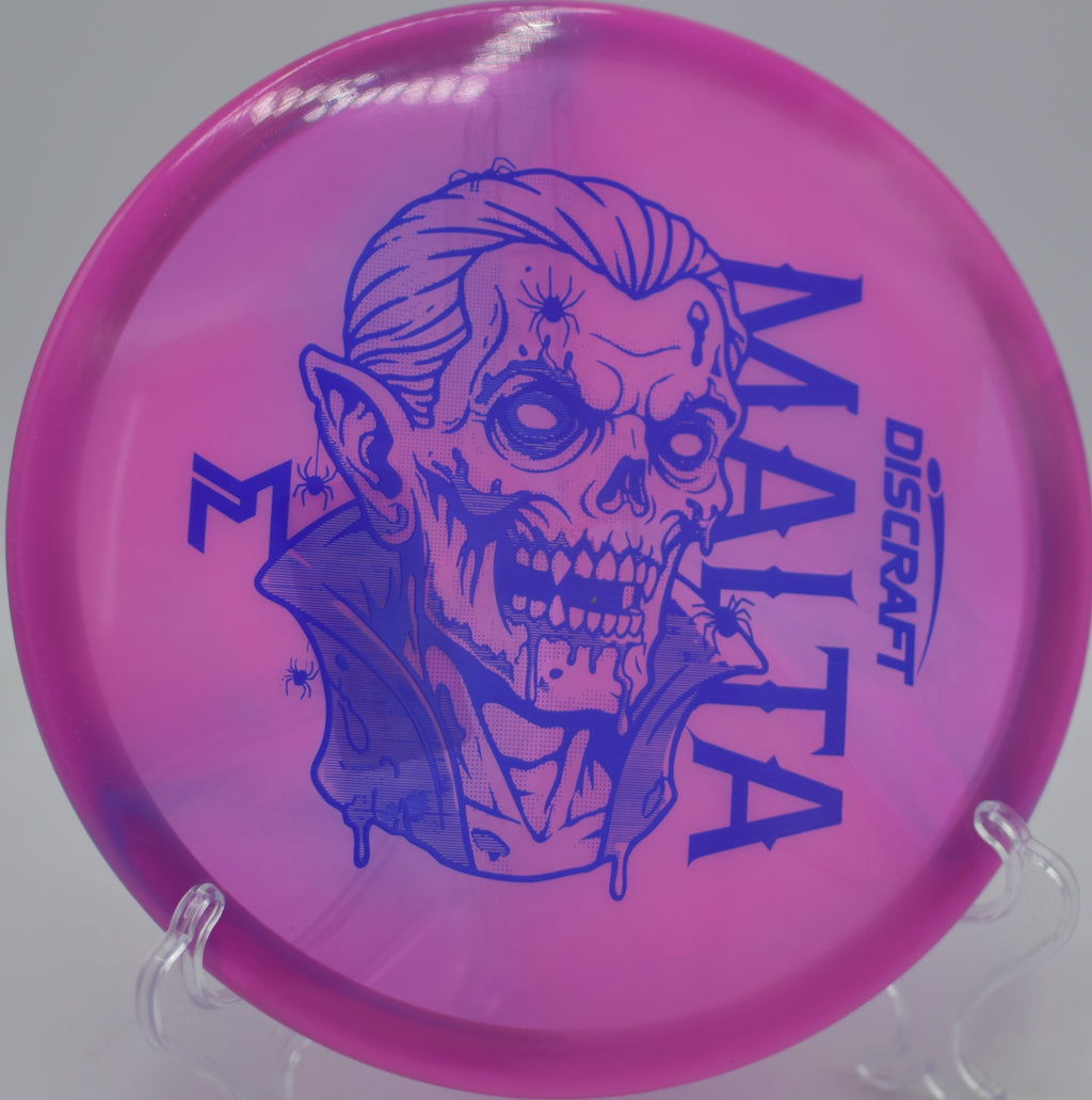 McBeth Dracul Malta flying perfectly straight under bright Florida sun at North Fort Myers Community Park Disc Golf Course in North Fort Myers, Florida.
