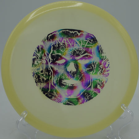 Player gripping a Mint Discs Nocturnal Glow Lobster under UV light at Morley Field Disc Golf Course in San Diego, California.