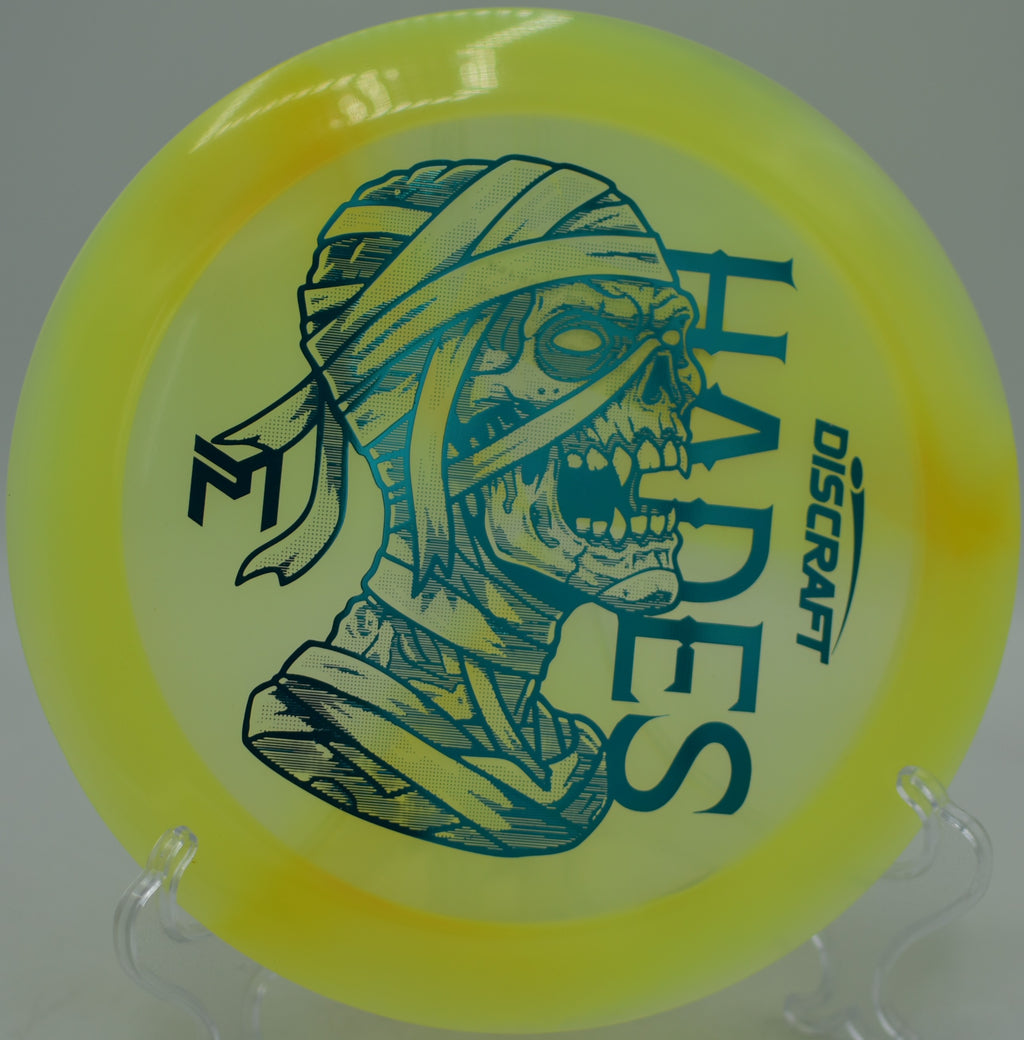 Discraft Z Swirl “Mummified” Hades flying over a water carry at Stafford Lake Disc Golf Course in Novato, California.