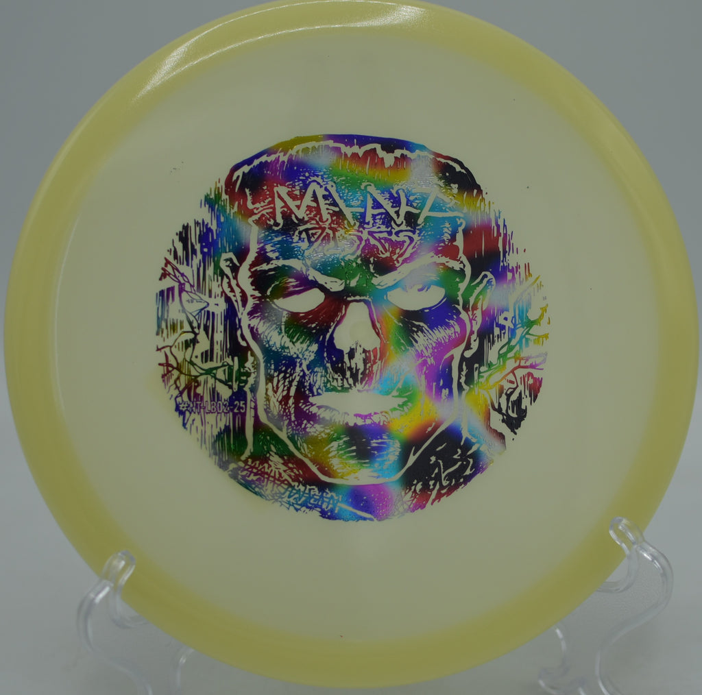 Mint Discs Halloween Lobster glowing green as it glides toward the basket at Waterworks Park Disc Golf Course in Kansas City, Missouri.