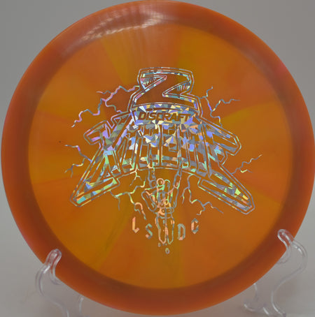 Player ripping a Discraft Ledgestone Xtreme Z Swirl on a headwind drive at Blue Ribbon Pines Disc Golf Course in East Bethel, Minnesota.