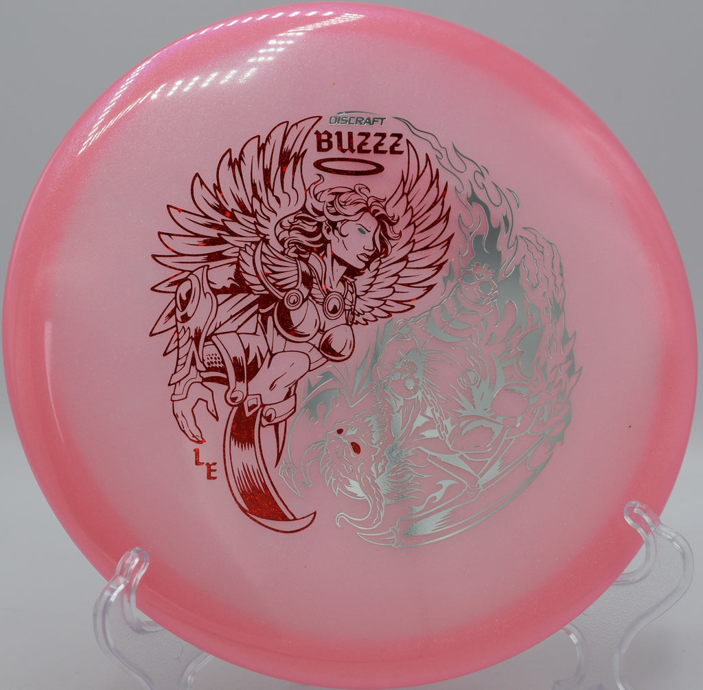 Discraft Buzzz in Colorshift Z Glo plastic hovering over the fairway at Blue Ribbon Pines in East Bethel, Minnesota, delivering dependable glide and fade.