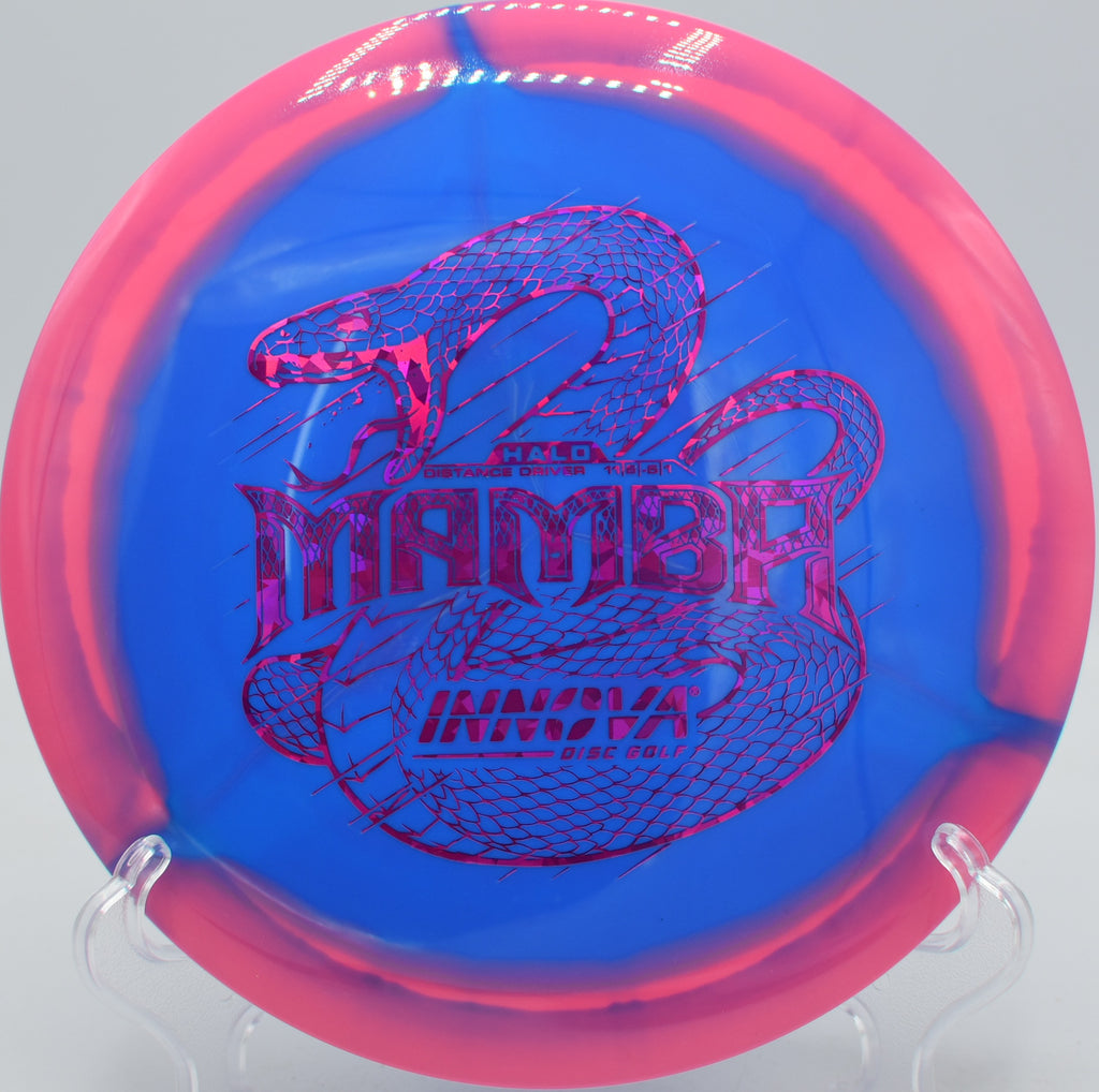Innova Halo Star Mamba understable driver soaring through a wooded fairway at Northwood Black Disc Golf Course in Morton, Illinois