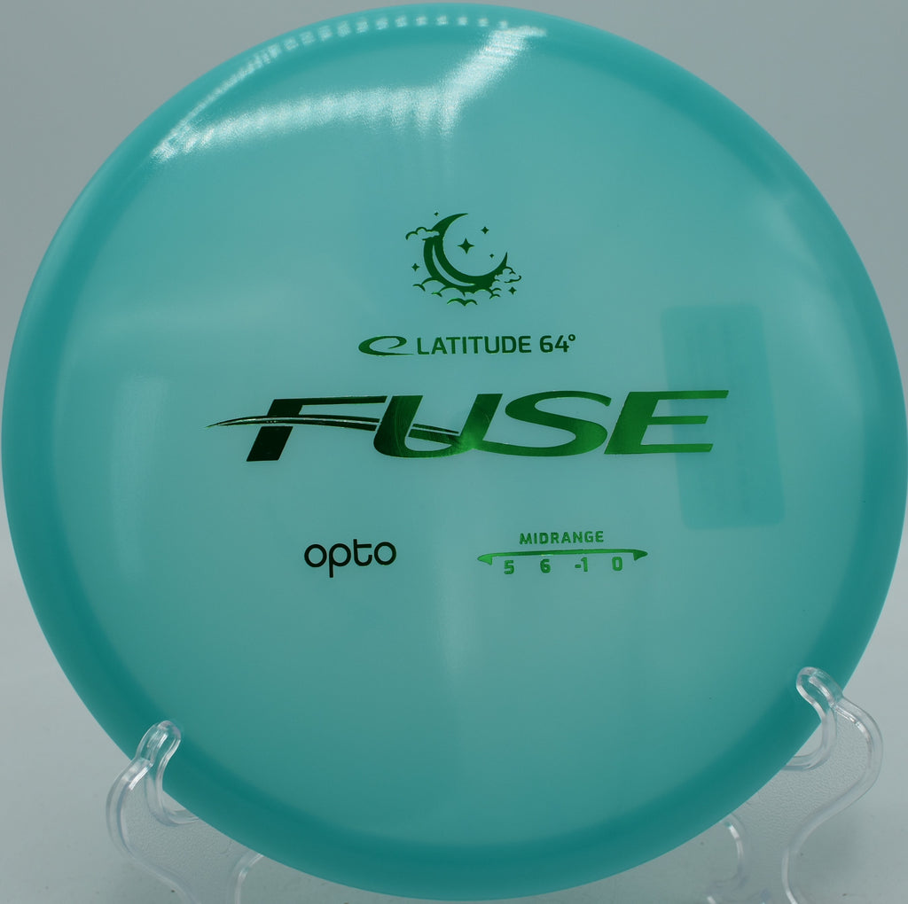 Opto Moonshine Fuse Latitude 64° glow disc floating on a straight hyzer-flip at Idlewild Disc Golf Course in Burlington, Kentucky.