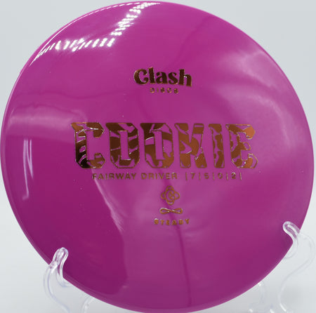 Clash Discs Steady Cookie in mid-flight at Flip City Disc Golf Park in Shelby, Michigan, highlighting its balanced flight and smooth hand feel.