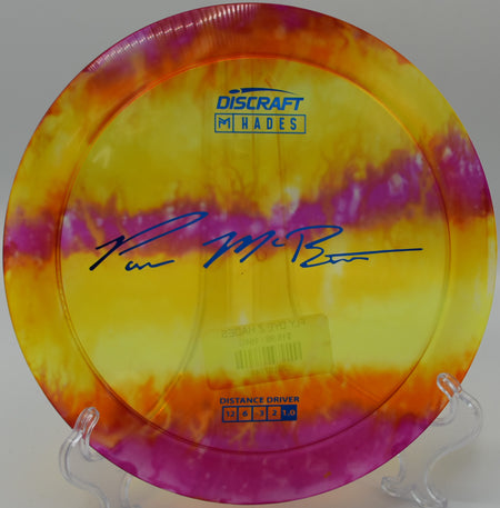 Color-swirled FlyDye Hades launching on a big hyzer flip at North Cove DGC in North Carolina.