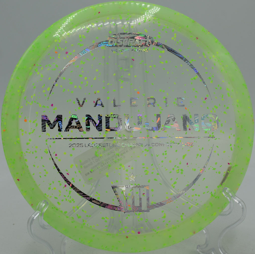 Confetti Z Glide carving hyzer flip through trees at Flip City Disc Golf Course in Shelby, Michigan