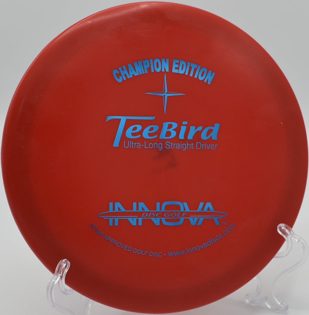 Champion Edition Teebird disc landing accurately near the basket at Sabattus Disc Golf Course, Maine.