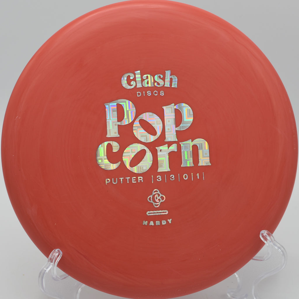 Clash Discs Popcorn floating smoothly over the green on Hole 6 at Bucksnort Disc Golf Course, Pine, Colorado.