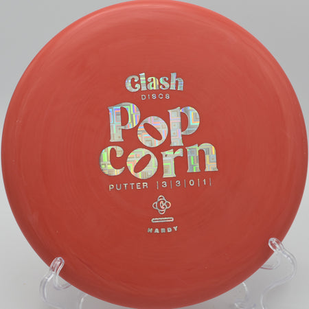 Clash Discs Popcorn floating smoothly over the green on Hole 6 at Bucksnort Disc Golf Course, Pine, Colorado.