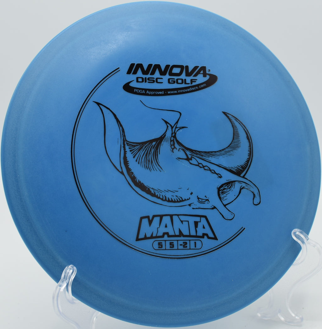 An Innova DX Manta parked under the basket at Lovers Lane Disc Golf Course in Bowling Green, Kentucky, after a finesse approach shot.
