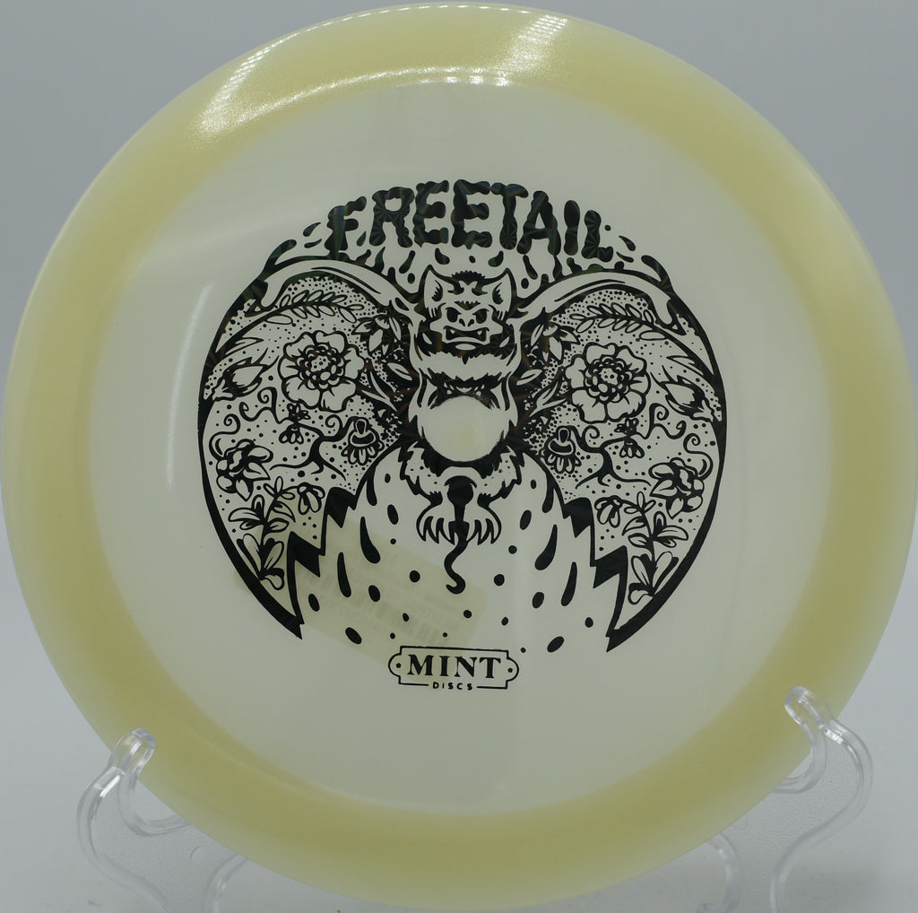 Mint Discs Nocturnal Freetail glowing as it approaches the basket on Hole 11 at Sunrise Disc Golf Course, Des Moines, Iowa.