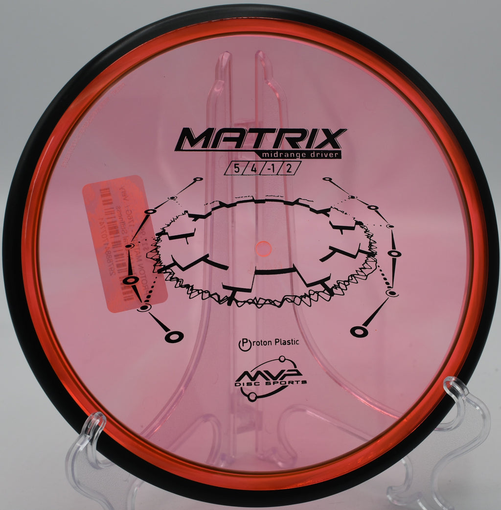 An MVP Proton Matrix floating smoothly through a wooded fairway at Sabattus Disc Golf Course in Sabattus, Maine.