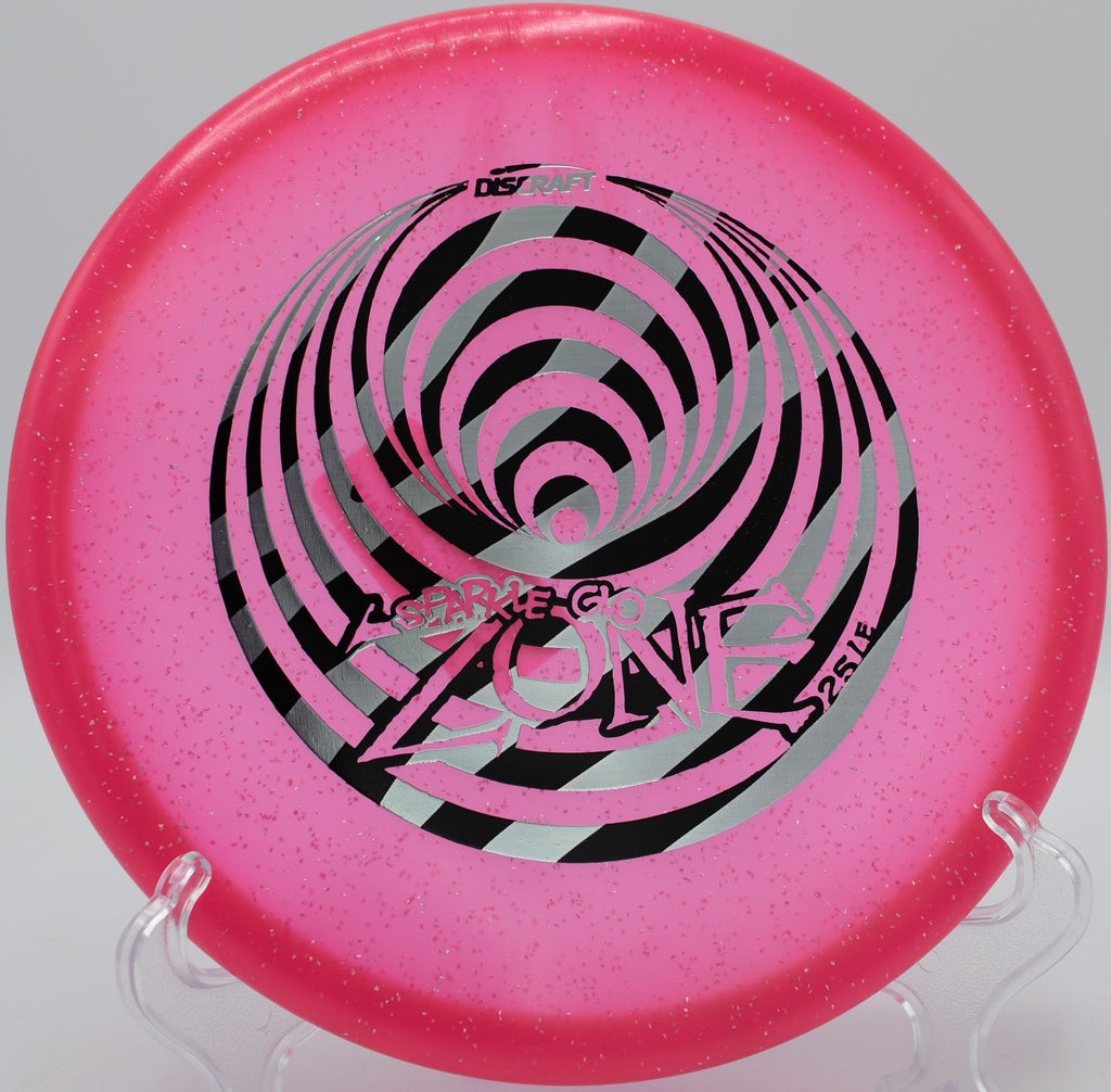 Discraft Glo Sparkle Zone landing on basket's edge at Patriots Park in Grovetown, Georgia