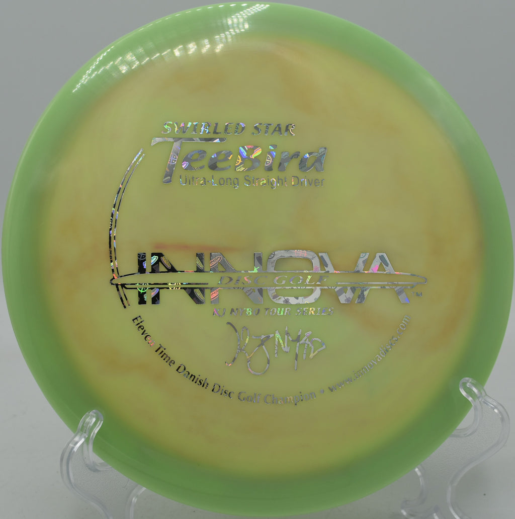 Close-up of Swirly Star TeeBird’s vibrant color pattern on the tee pad at DeLaveaga Disc Golf Course in Santa Cruz, California