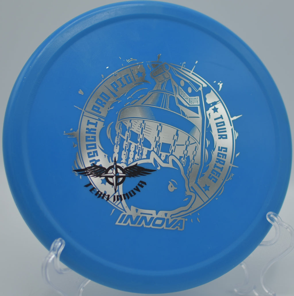 Innova R-Pro Pig (2019 Ricky Wysocki Team Stamp) Field Tested 8.5/10 resting on trimmed grass at Winthrop Gold Disc Golf Course in Rock Hill, South Carolina, showing light wear from use and the iconic Ricky Wysocki team stamp.