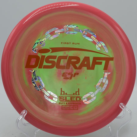 Discraft First Run ESP Sled stable putter approach disc parked under the basket at Maple Hill Disc Golf Course in Leicester, Massachusetts