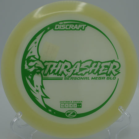 Mega Glow Z Thrasher glowing mid-flight on a smooth hyzer-flip at Maple Hill Disc Golf Course in Leicester, Massachusetts.