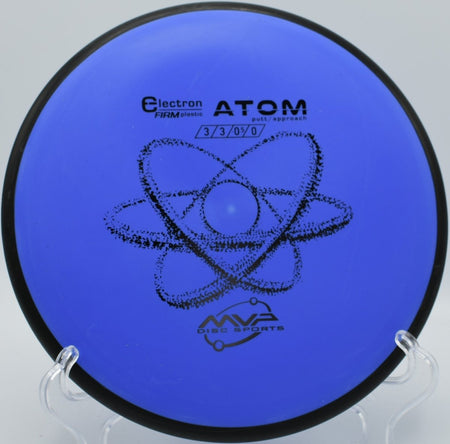 Electron Firm Atom disc golf putter resting on the putting green beside the cage at Brecksville Reservation Disc Golf Course in Brecksville, Ohio