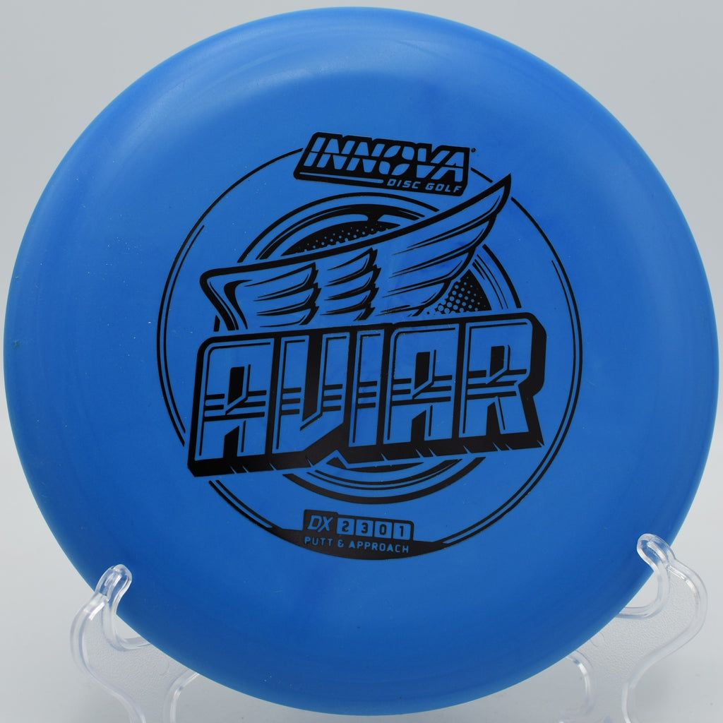 DX Aviar disc held on a clean hyzer putt at Blue Ribbon Pines Disc Golf Course in East Bethel, Minnesota