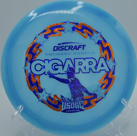 Discraft Z-Swirl Cigarra fairway driver resting on the tee pad at Lime Hollow DGC in Cortland, NY, showcasing its glidey 7-speed flight for technical fairways.