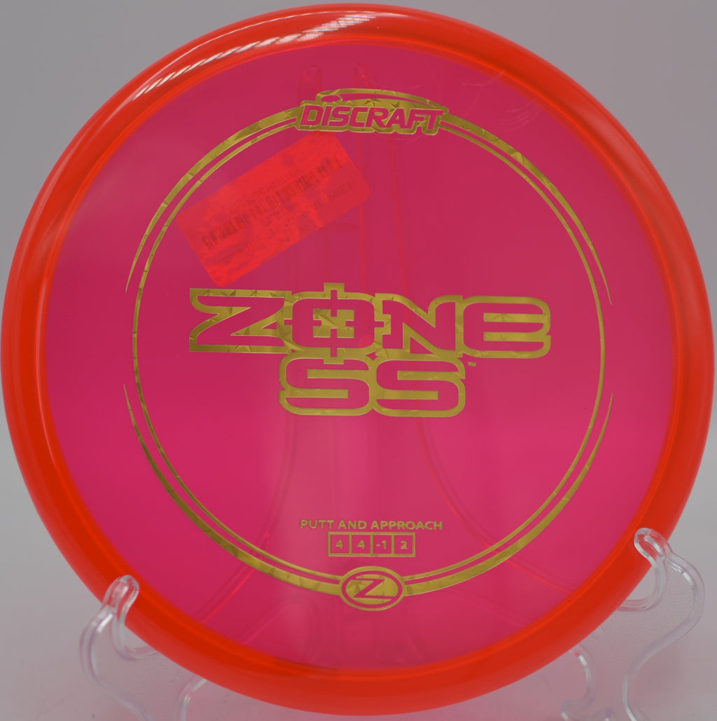 Discraft Z Zone SS approach putter flying straight at Maple Hill Disc Golf Course in Leicester, Massachusetts.