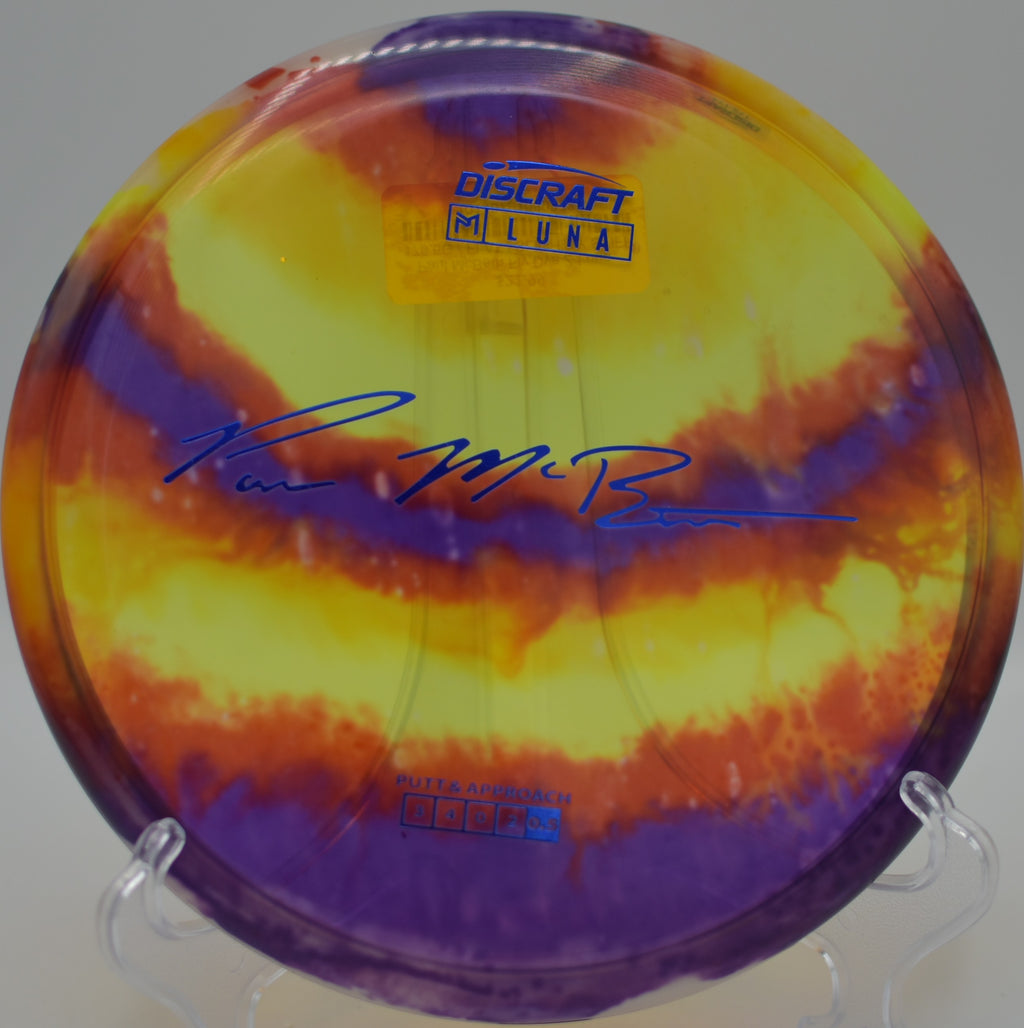 Paul McBeth Fly Dye Z Luna resting on the putting circle at Jones Park East DGC in Emporia, KS, showcasing its stable 3-speed flight and vibrant dyed pattern.