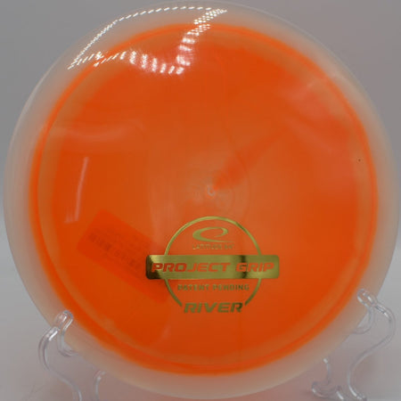 Latitude 64 Project Grip River fairway driver gliding straight on wooded fairway at Pier Park Disc Golf Course in Portland Oregon