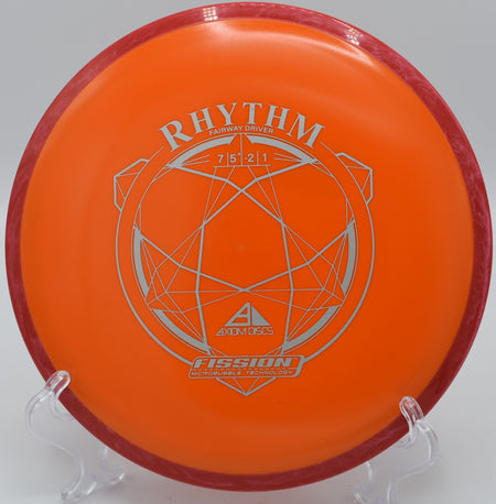 A disc golfer throwing a long, straight drive with a Fission Rhythm at Bucksnort Disc Golf Course in Pine, Colorado.