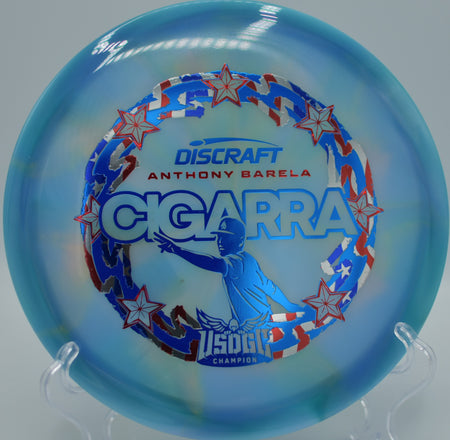 Z-Swirl Cigarra photographed under sunlight at Hawk Hollow DGC in Spotsylvania, VA, highlighting its swirl pattern and smooth hyzer-flip potential.