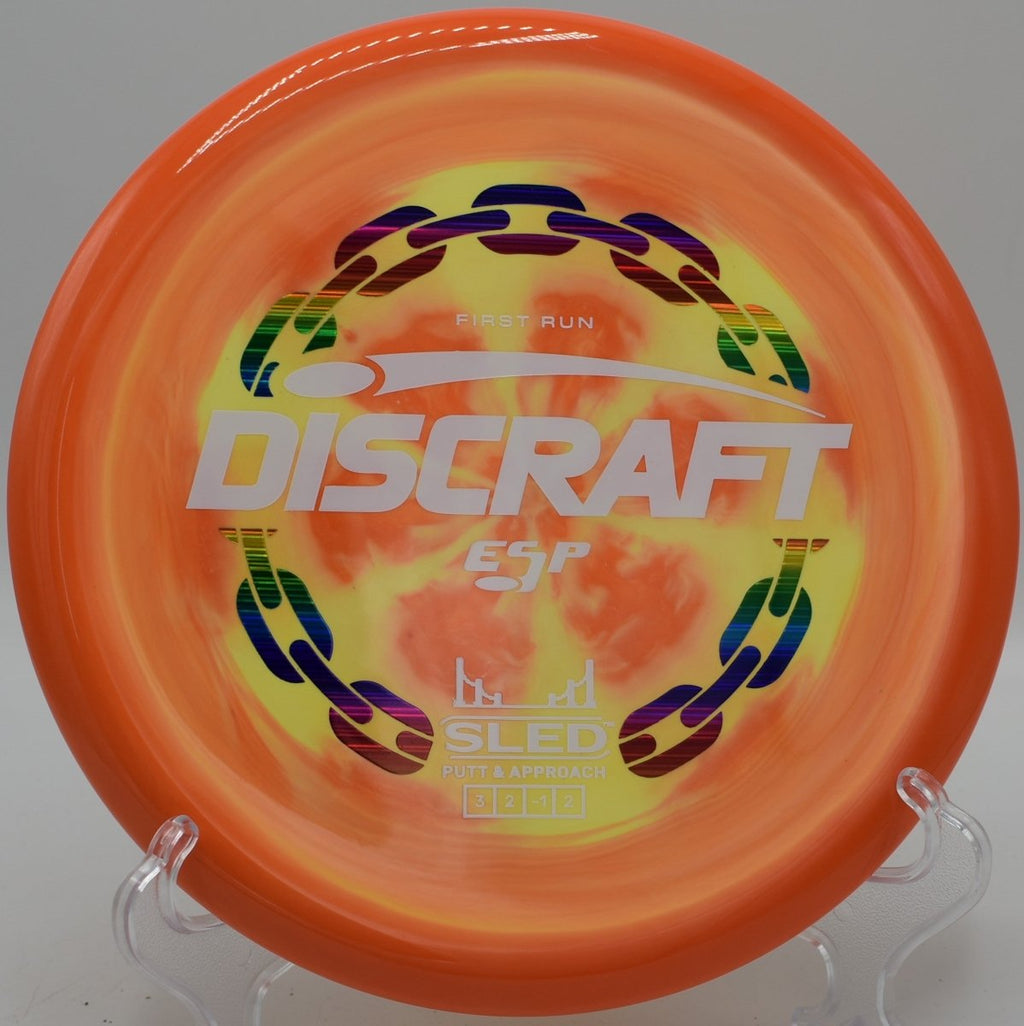 First Run ESP Sled controlled approach disc settling softly near chains at Idlewild Disc Golf Course in Burlington, Kentucky