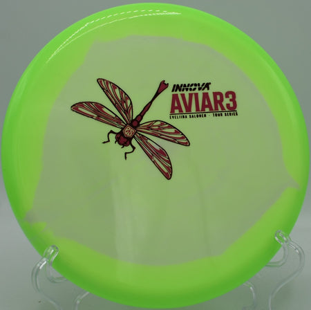 Halo Star Aviar3 overstable driving putter resting on the putting green beside the cage at Kahuku Disc Golf Course in Kahuku, Hawaii