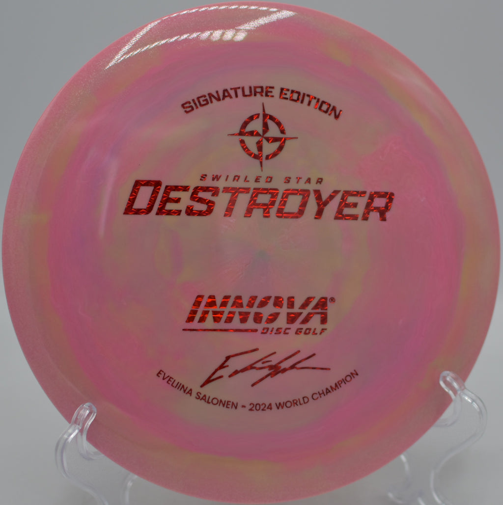 Innova Swirled Star Destroyer flying on a massive hyzer flip over the fairway at Morley Field Disc Golf Course in San Diego, California.