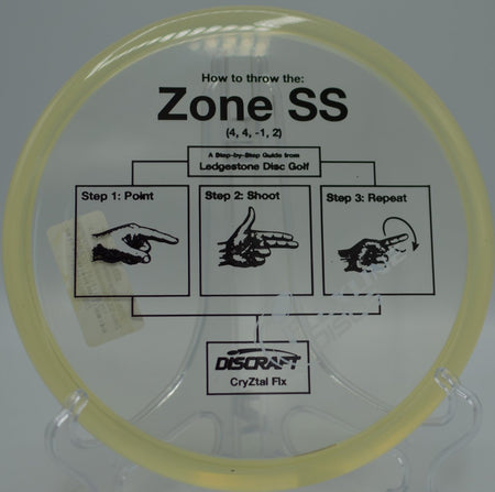 Discraft Zone SS in CryZtal FLX plastic landing softly near the basket on a finesse backhand at McPherson Park Disc Golf Course in Flagstaff, Arizona