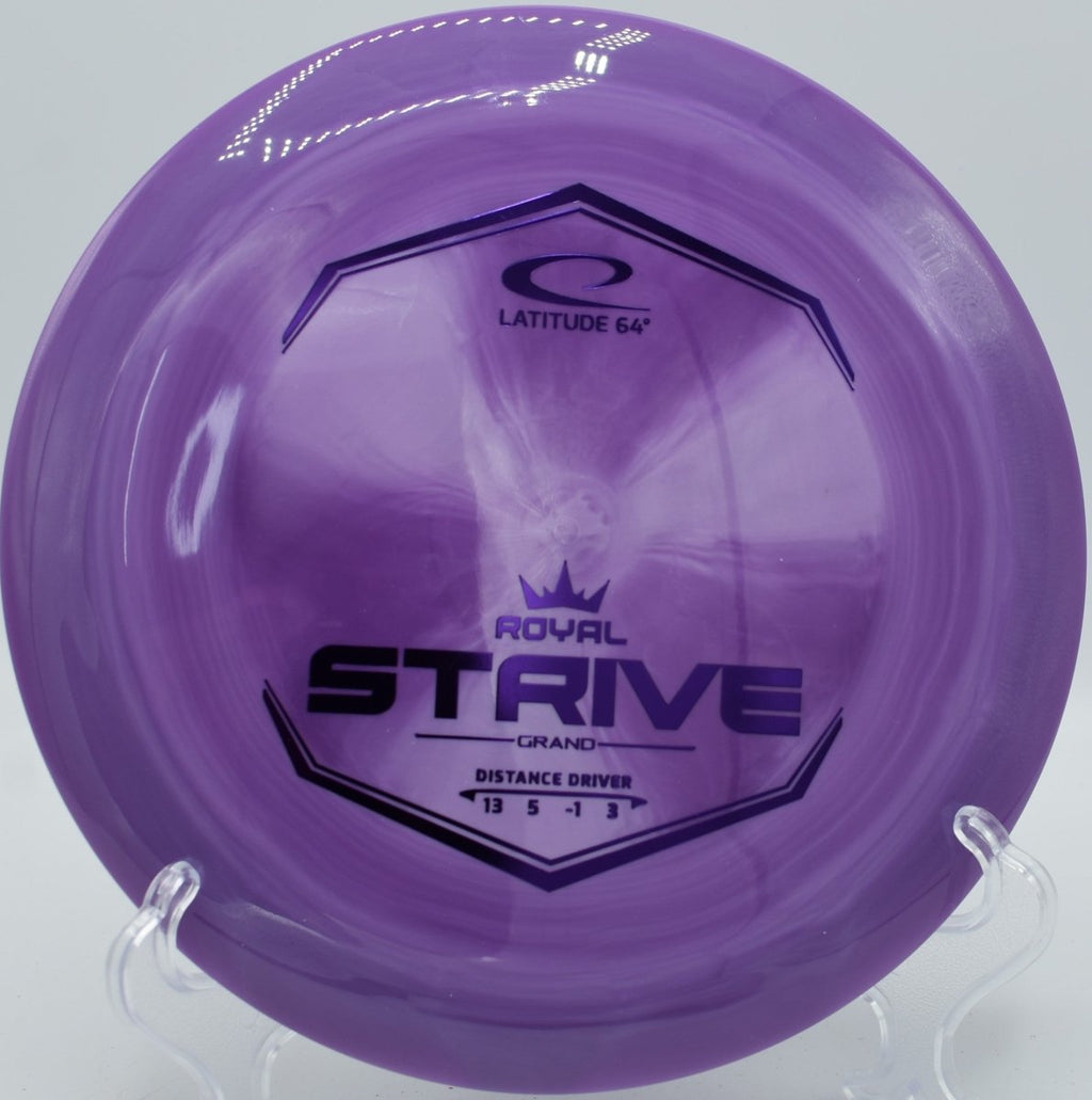 Latitude 64 Grand Strive high-speed distance driver resting in fairway grass at Milo McIver Disc Golf Course in Estacada, Oregon