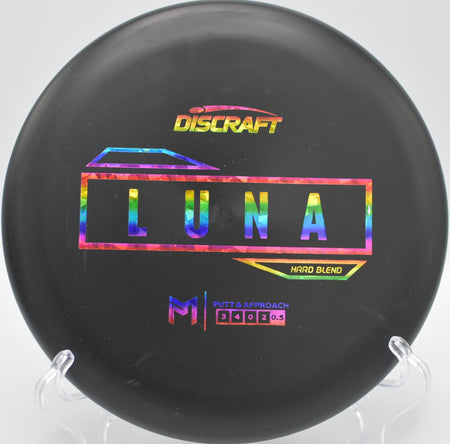 Discraft Hard Blend Luna floating straight toward the basket during a calm round at Pier Park Disc Golf Course in Portland, Oregon.