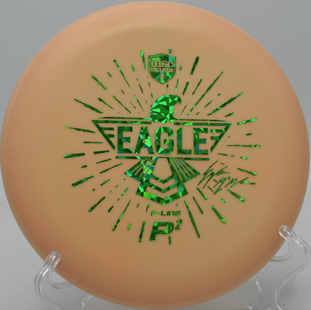 Discmania Eagle Totem P2 shining through a wooded fairway on a clean hyzer approach at The Fort in Ogden, Utah.

