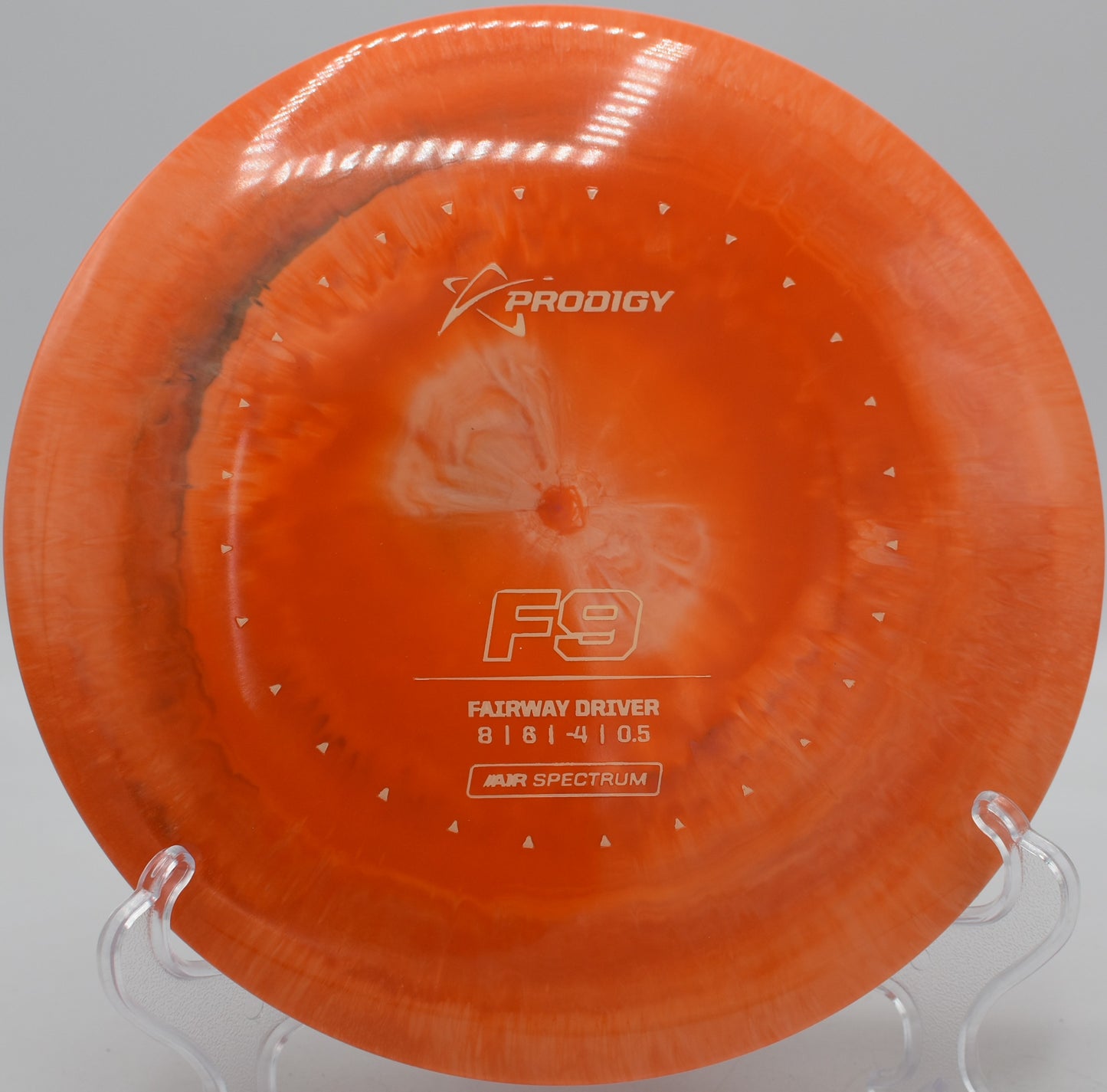 Lightweight Air Spectrum F9 carving a hyzer flip through wooded fairway at Camp Sekani Disc Golf Course, Spokane, Washington.