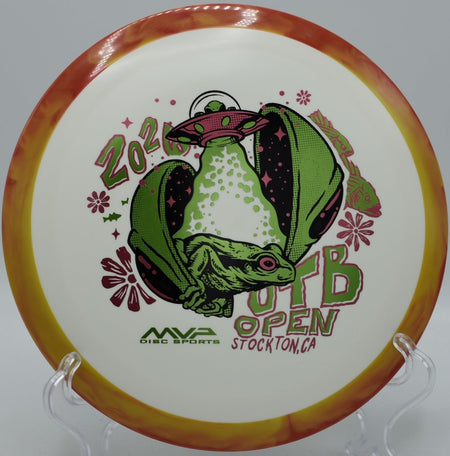 OTB Open Fission Delirium 2026 edition high-speed disc golf driver resting in fairway grass at DeLaveaga Disc Golf Course in Santa Cruz, California