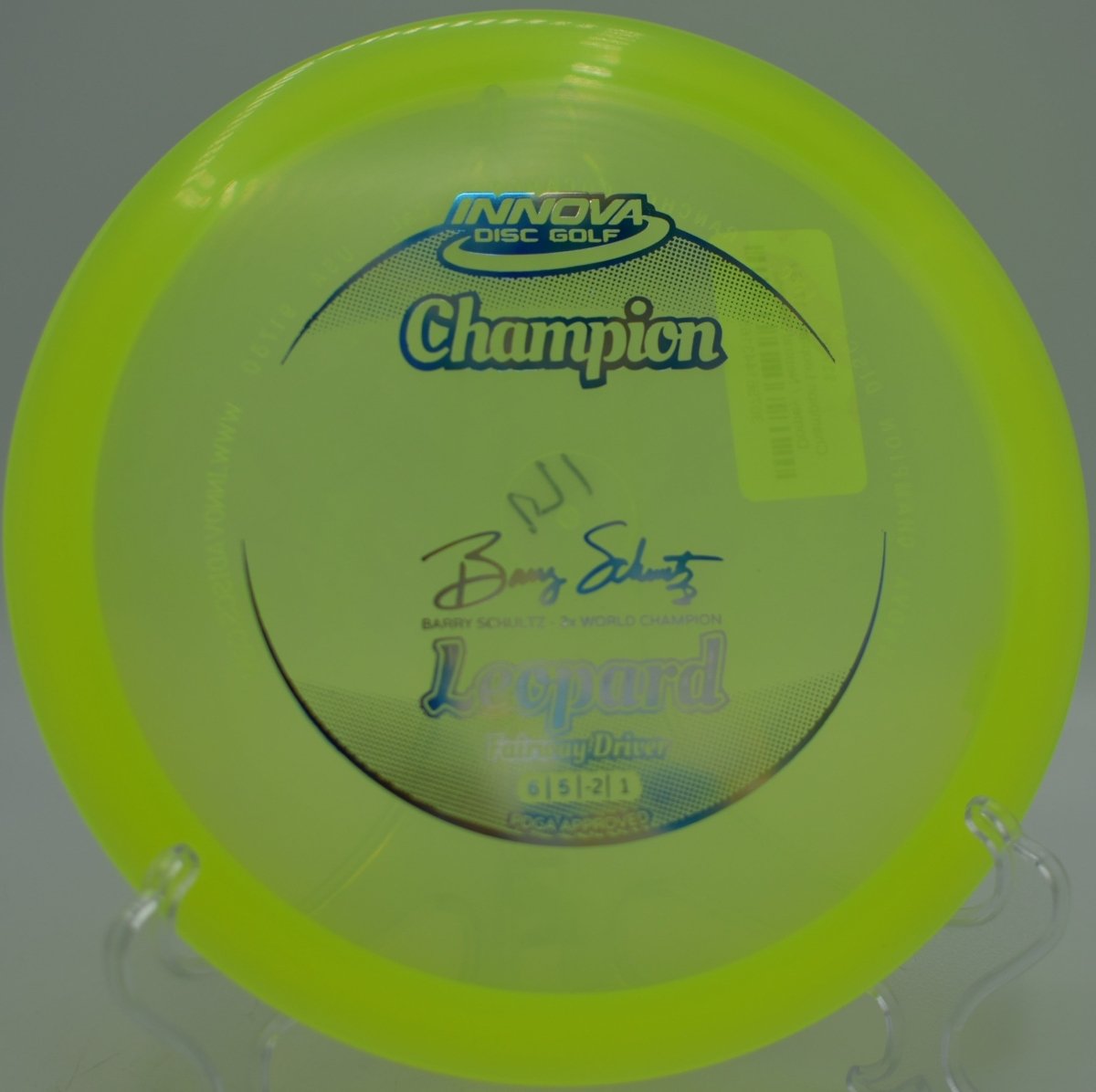 Champion Leopard fairway driver carving a hyzer flip through tight fairway gap at Riverview Park Disc Golf Course in Mesa, Arizona