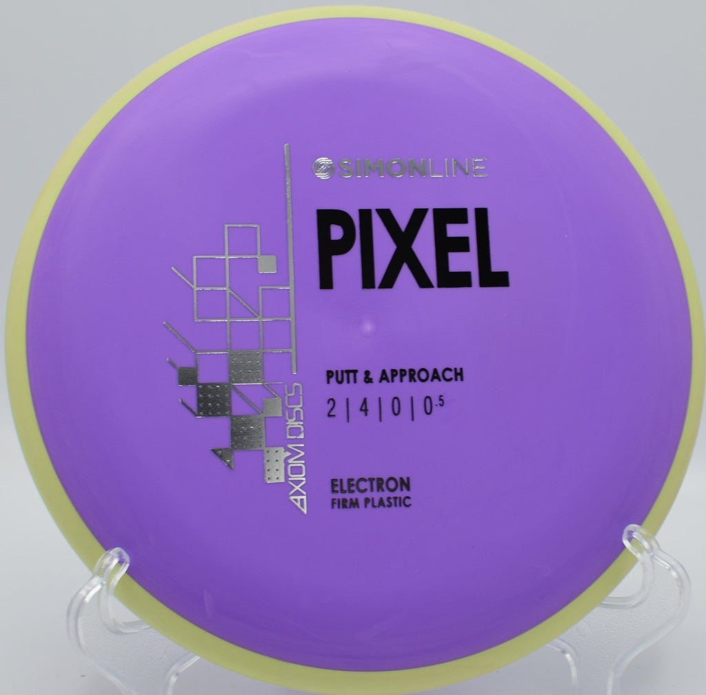 Electron Firm Pixel putter resting beside basket pole after a straight glide upshot at Rocky Hills Disc Golf Course in Oxford, Connecticut