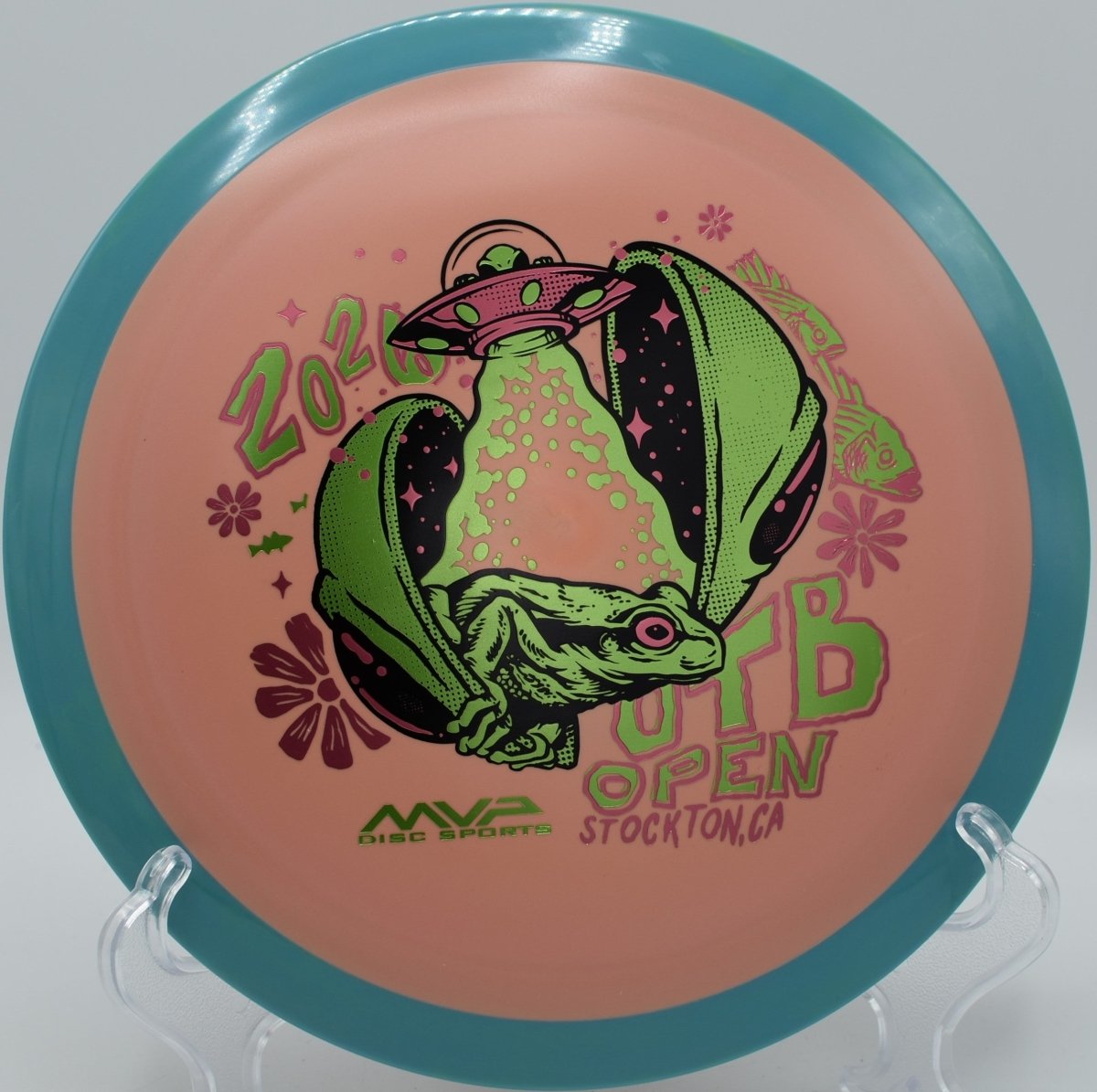 Axiom Fission Delirium OTB Open fundraiser driver photographed beside basket at Idlewild Disc Golf Course in Burlington, Kentucky